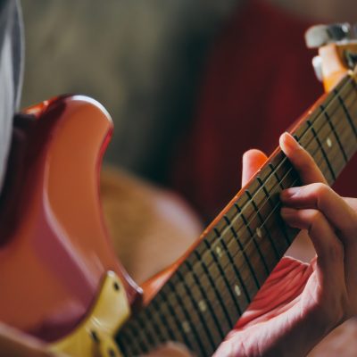 close-up-of-male-hands-playing-electric-guitar-selective-focus.jpg